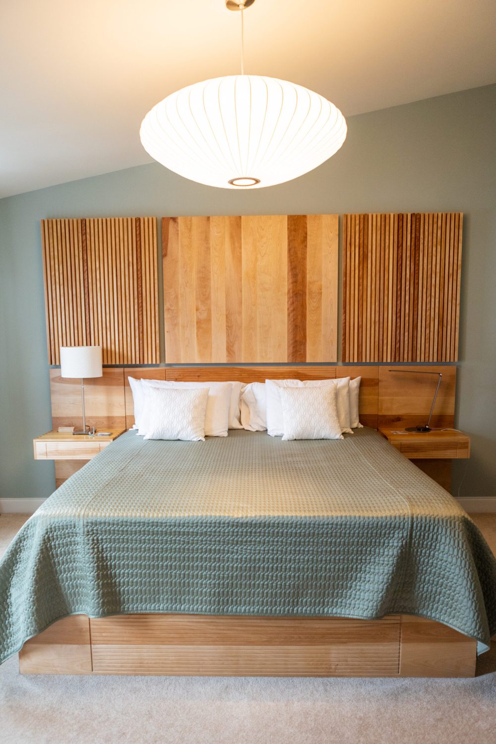 Bedroom set with dovetailed floating night stands and wall paneling to match. Birch wood